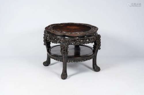 A richly carved Chinese hardwood table, 19th C.<br />
H 62 -...