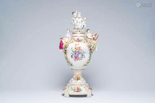 A large German flower encrusted putti crowned vase and cover...