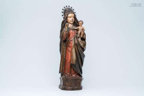 A large polychromed wood sculpture of a Madonna with Child, ...