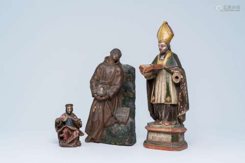 Three polychromed wood sculptures of a bishop, God the Fathe...