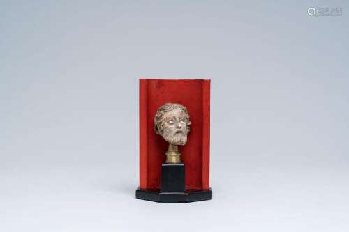 A painted terracotta head with glass eyes, probably 17th C.<...