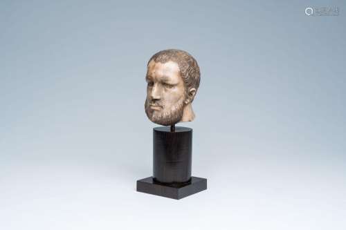 An alabaster head of a bearded man with traces of polychromy...