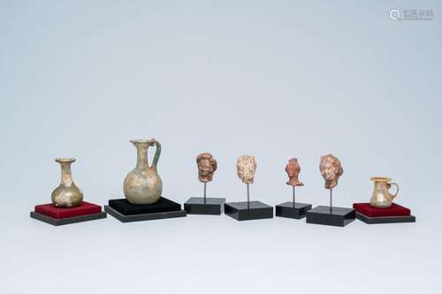 Four Greek terracotta female heads and three Roman glass jug...