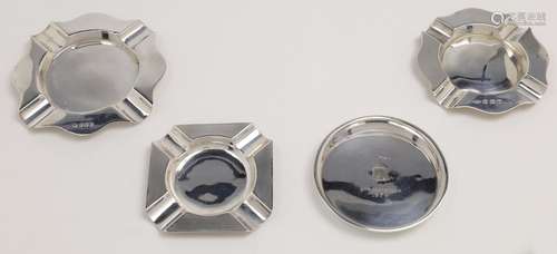 Three silver ashtrays, comprising: a square engine turned as...