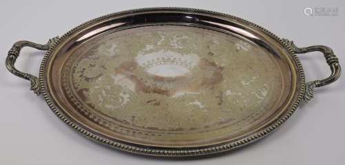 A silver plated twin handled tray, of oval form with chased ...