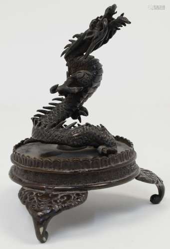 A Japanese bronze figure of a dragon, Meiji period, cast ris...
