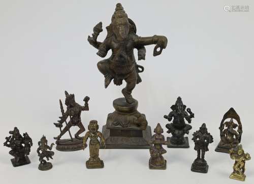 A bronze figure of a dancing Ganesha atop a leaf moulded bas...