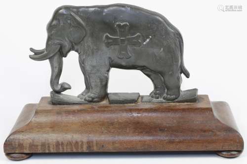 A lead plaque in the form of an Indian elephant atop a plint...