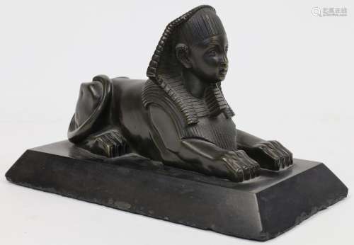 A bronze model of a recumbent sphinx, early 20th century, on...