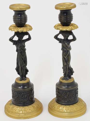 A pair of French bronze and ormolu figural candlesticks, 19t...
