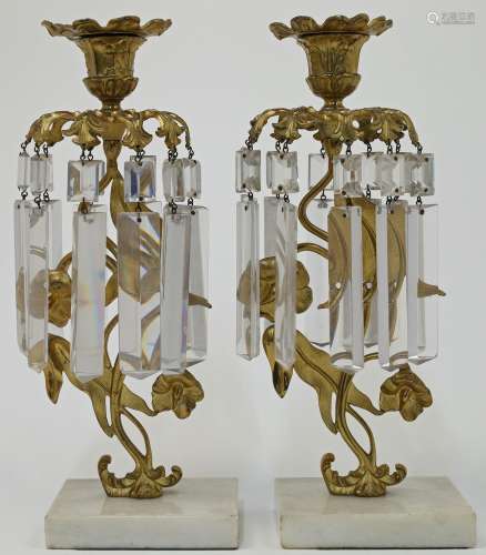 A pair of French gilt metal and cut glass candlestick lustre...