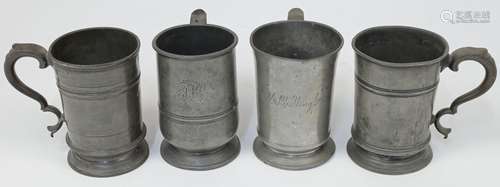 Four pewter quarts,18th / 19th century, each with scrolling ...