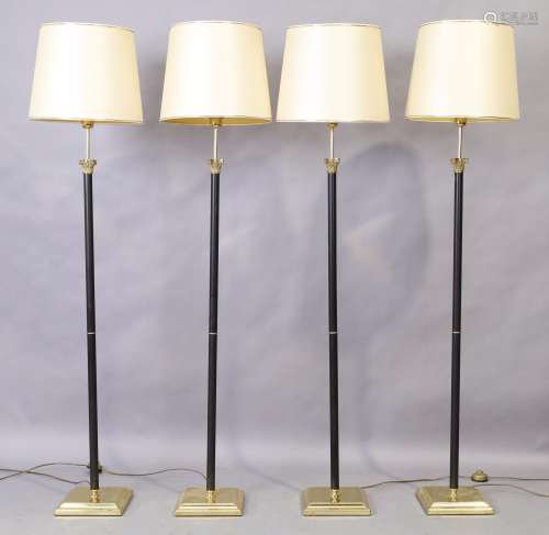 A set of four brass and black lacquered standard lamps, late...