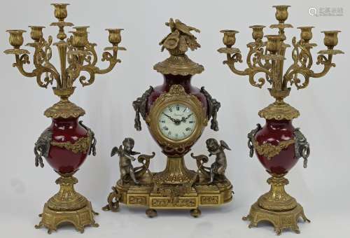 A gilt-metal and enamel clock garniture, the central clock w...
