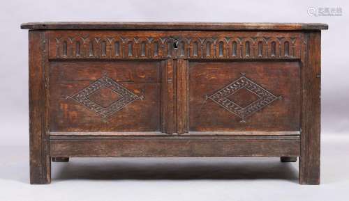 An English oak coffer, 18th century, the hinged top enclosin...