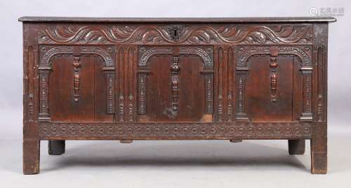 An English oak coffer, 18th century, the hinged top enclosin...