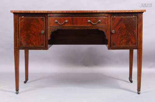 A George III style mahogany serpentine front writing table, ...