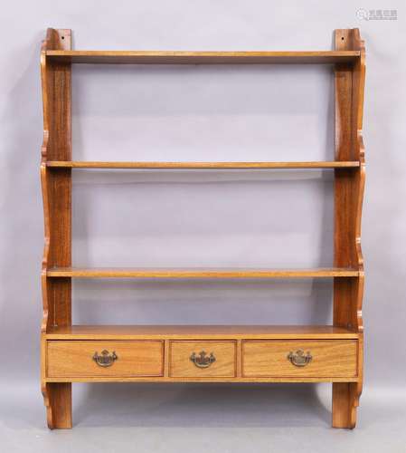 A large George III style mahogany wall hanging shelf, 20th c...