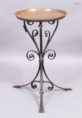 An Arts and crafts wrought iron table, with incised circular...