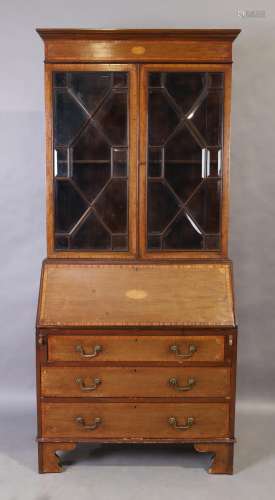 An Edwardian Sheraton revival mahogany bureau bookcase, the ...