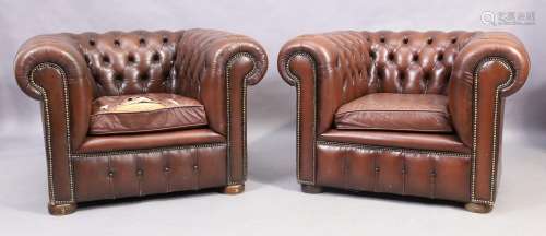 A pair of chesterfield brown leather armchairs, 20th century...