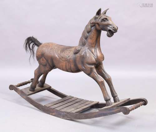 A carved wooden rocking horse, 20th century, 88cm high, 124c...