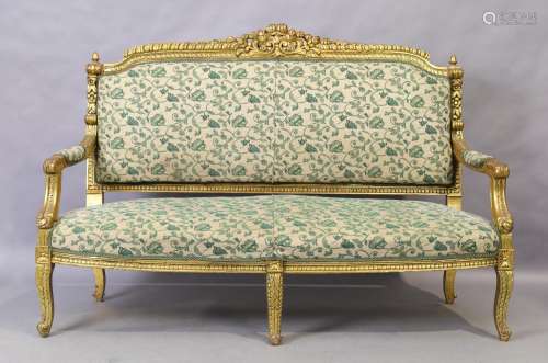 A Louis XV style giltwood sofa, 20th century, with cream gro...