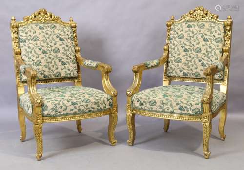 A pair of Louis XV style giltwood armchairs, 20th century, w...