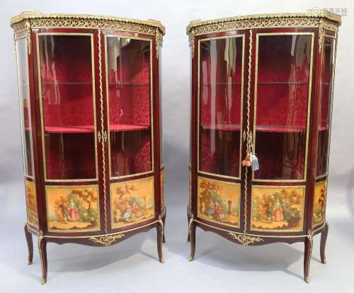 A pair of Louis XV style bow front vitrines, 20th century, g...