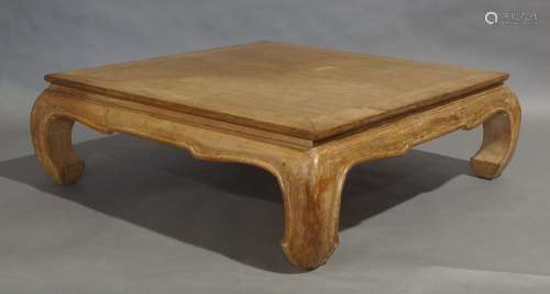 A Chinese style teak low table, square top raised on curved ...