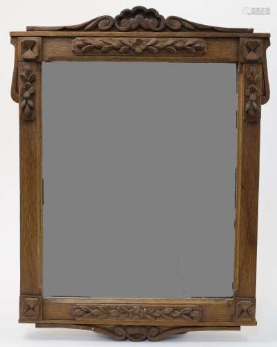 An Arts & Crafts style oak mirror, early 20th century, w...