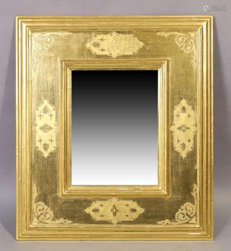 A modern giltwood mirror, with incised decoration and moulde...