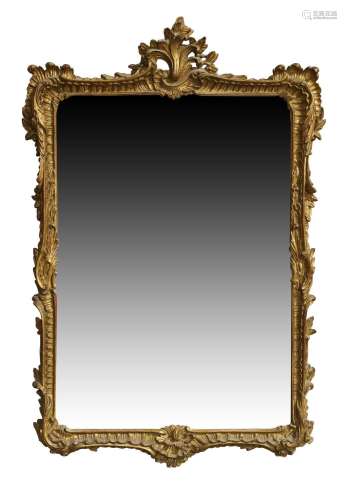 A French giltwood mirror, late 20th century, with carved flo...