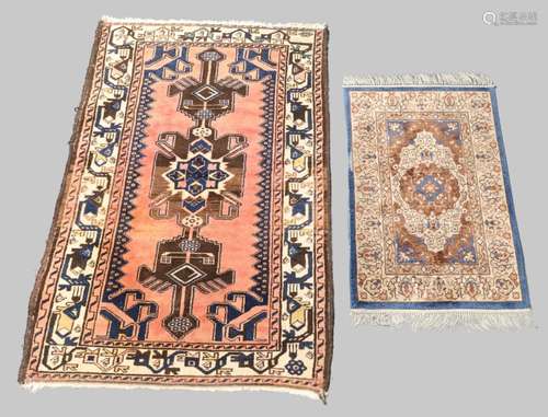 A Persian Kurdie rug with geometric medallion, on a salmon p...