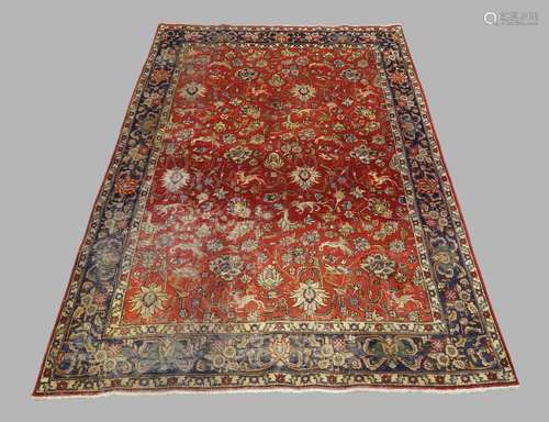 A Persian Sarouk carpet, the central field with floral and z...