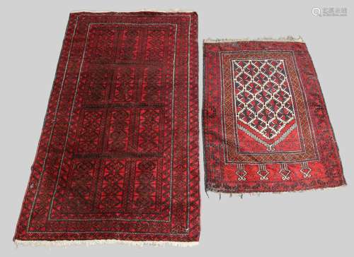 An Afghan Turkoman rug, geometric design on a red ground, 20...