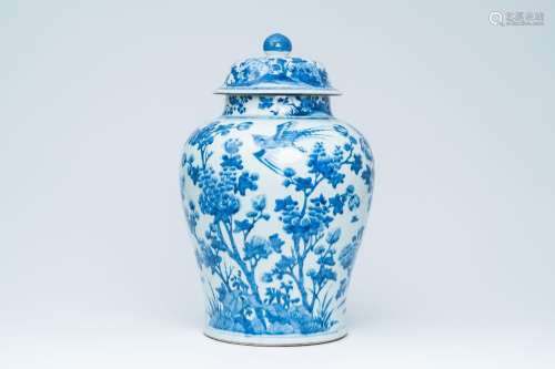 A large Chinese blue and white vase and cover with birds amo...