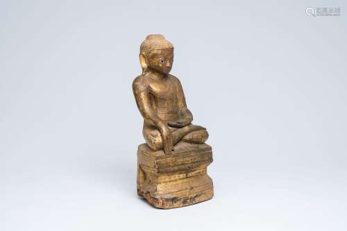 A large Burmese gilt wood sculpture of a seated Buddha, 19th...