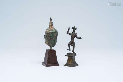 A bronze head of Buddha and a sculpture of a ritual dancer, ...