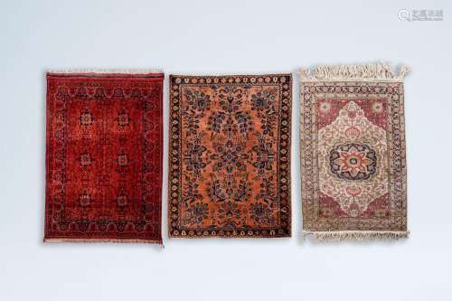 Three oriental rugs with floral design and geometric pattern...