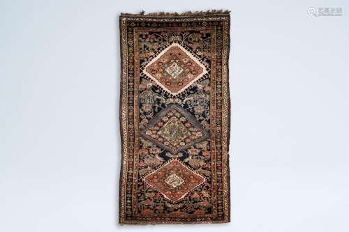 An oriental rug with birds among blossoming branches, wool o...