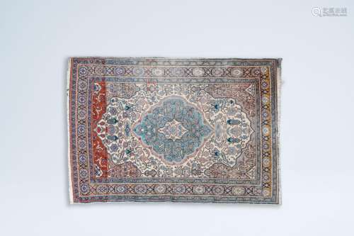 An oriental rug with floral design and geometric patterns, w...