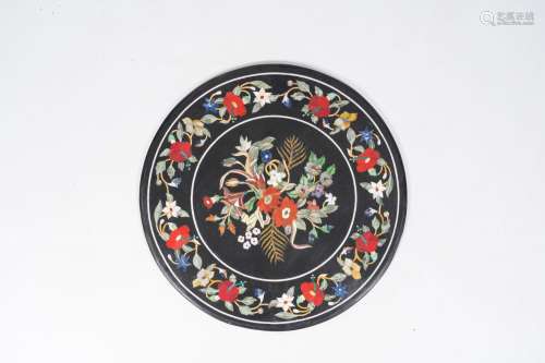 A large round Italian pietra dura table top with floral desi...