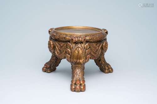 A gilded wooden stand on lion's feet, 19th C.<br />
H 30,5 c...