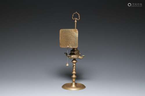 A four-arm brass whale oil lamp or lucerna, 19th C.<br />
H ...