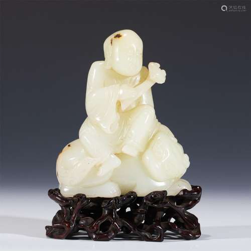 A CARVED JADE ARHAT WITH A TIGER