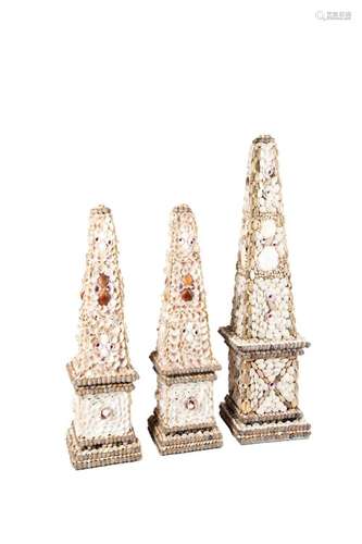 THREE NATURAL SHELL ENCRUSTED OBELISKS