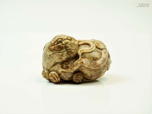 A Chinese pale grey-brown jade model of a Buddhist lion