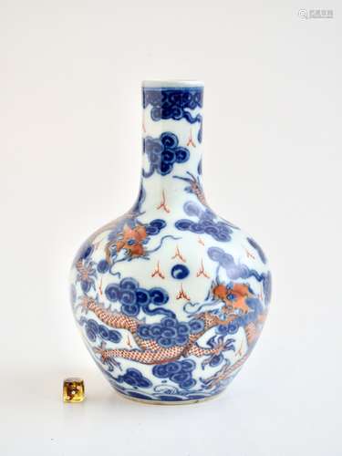 A Chinese iron-red and underglaze blue 'Dragons' bottle vase...