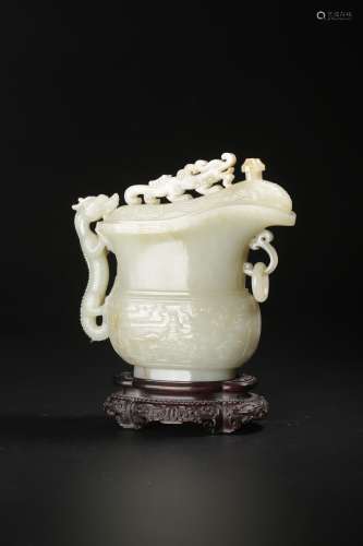 A white jade carving of an archaistic vessel and cover, W 15...